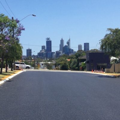 brand new road with no lines with the view of Perth city in the background